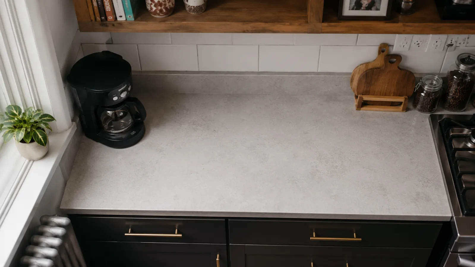 Small kitchen counter with only a compact coffee maker and kettle, showing open counter space
