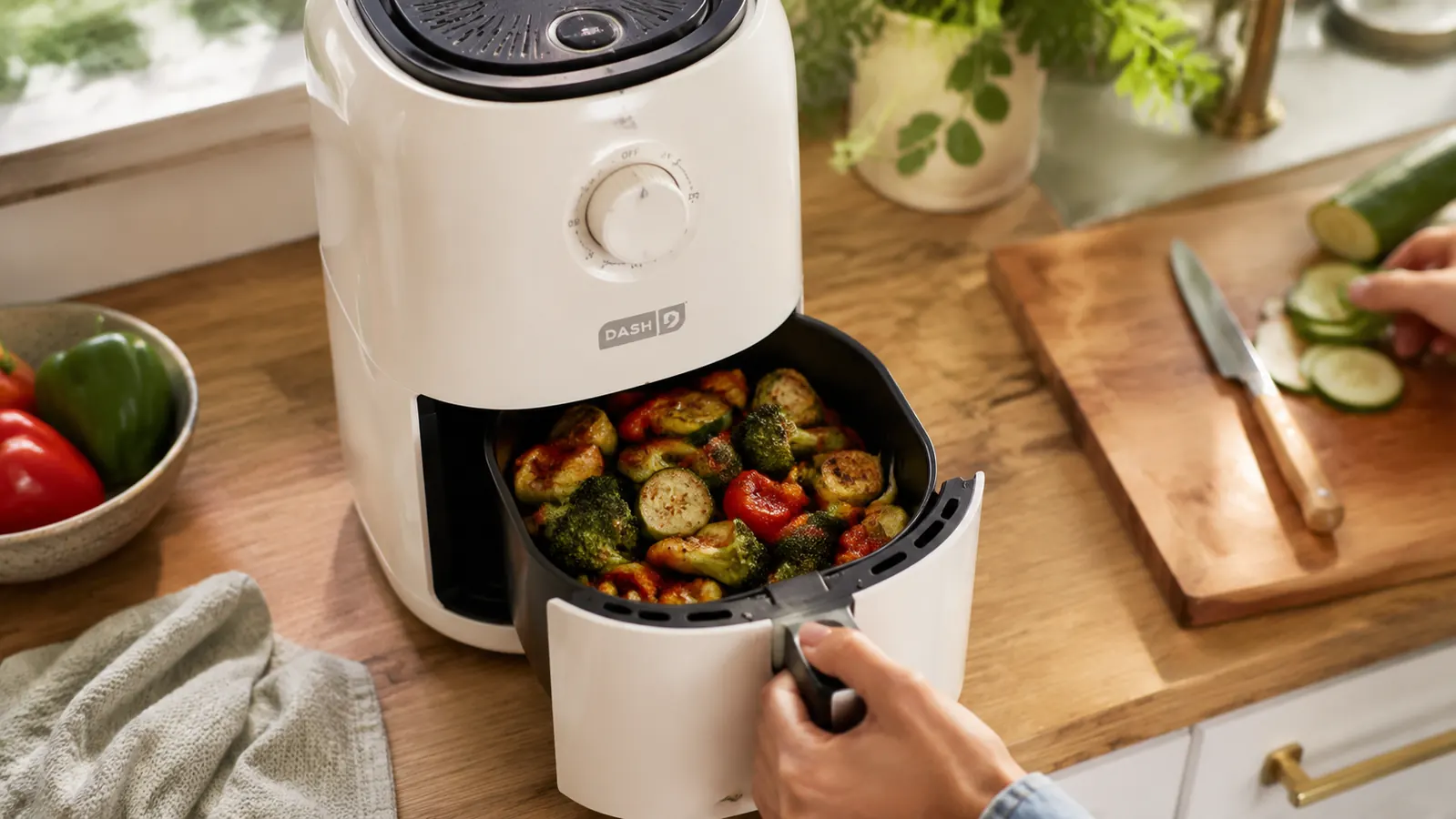 Crispy roasted vegetables in an air fryer basket ready to be served