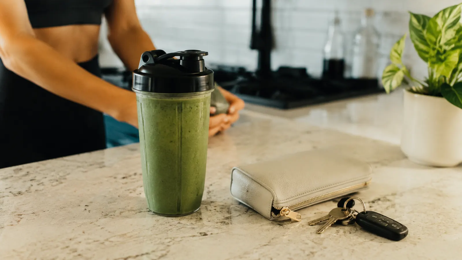 NutriBullet cup used as a to-go travel cup with a lid, sitting next to car keys on a counter
